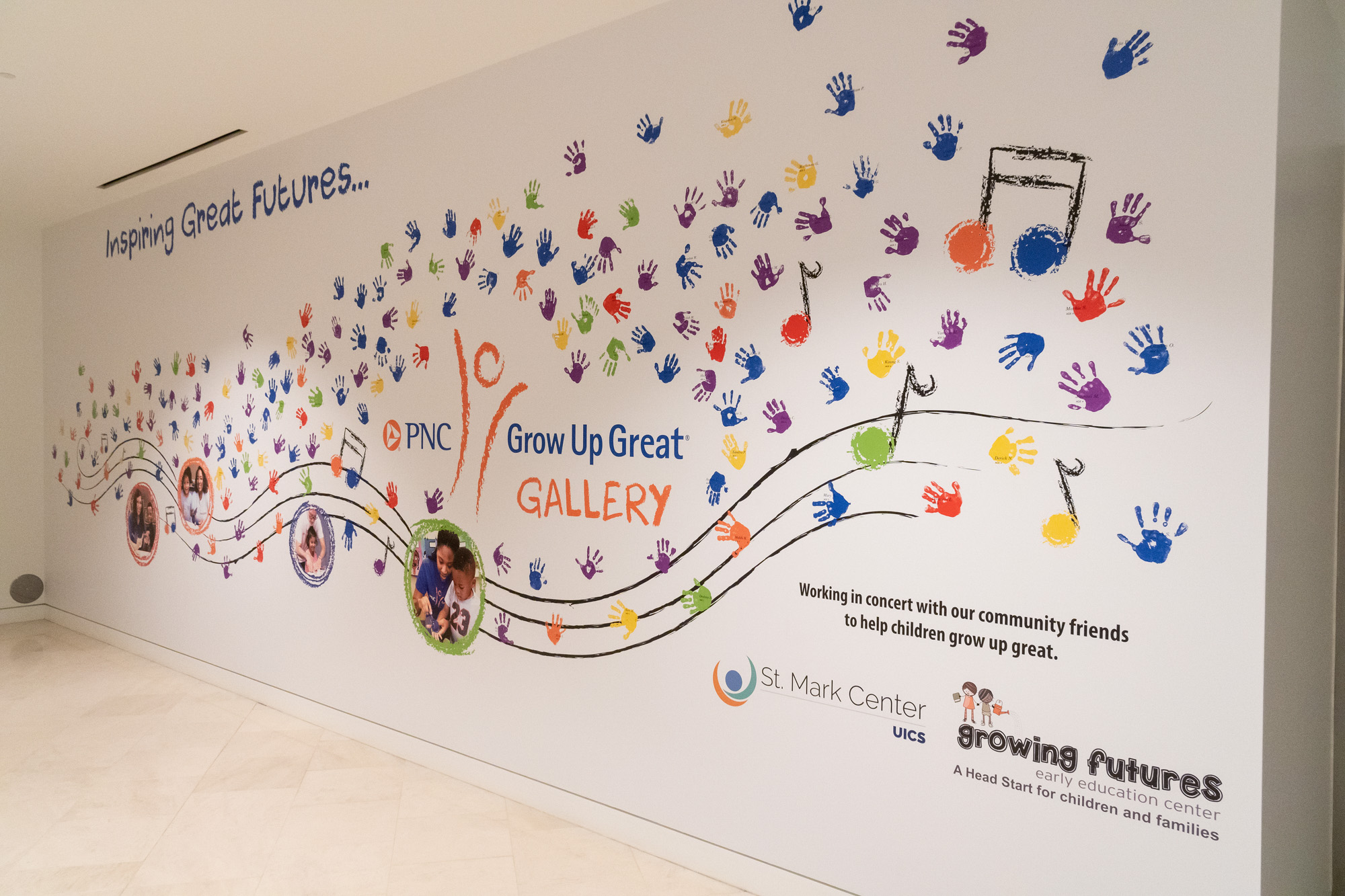 A mural with colorful handprints and music notes, promoting the "PNC Grow Up Great Gallery" in collaboration with St Mark Center, UIC, and Growing Futures, featuring the slogan "Inspiring Great Futures.