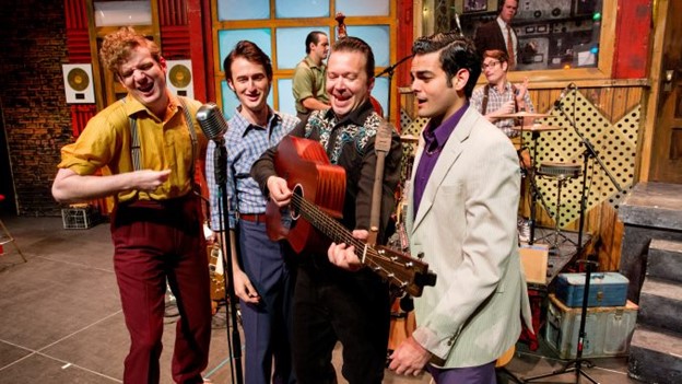 A group of men holding musical instruments